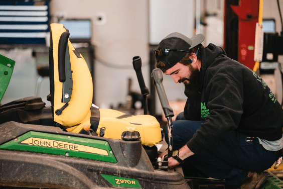 Technician servicing ztrak mower.